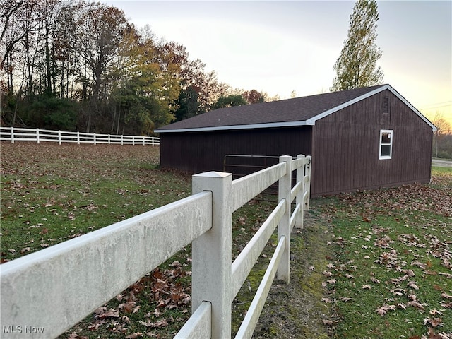 property exterior at dusk with an outbuilding