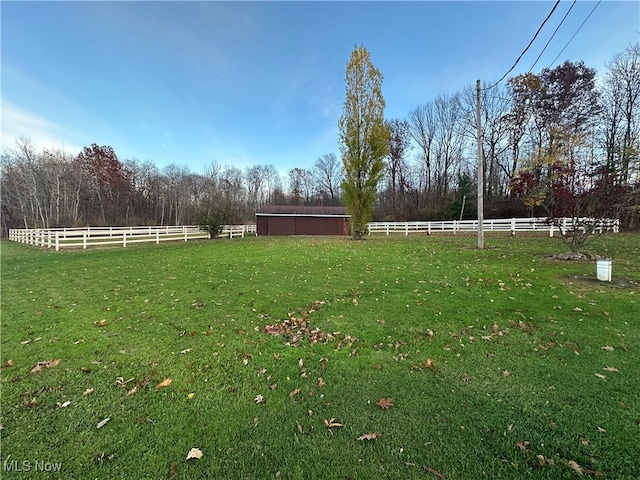 view of yard featuring a rural view and an outdoor structure