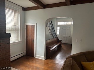 foyer entrance with beam ceiling, wood-type flooring, and a baseboard heating unit