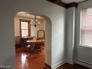 dining room with a notable chandelier, dark wood-type flooring, and a baseboard radiator