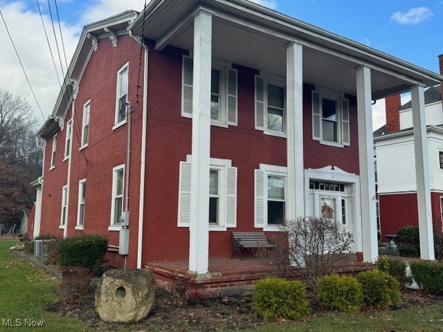 view of side of property featuring a porch