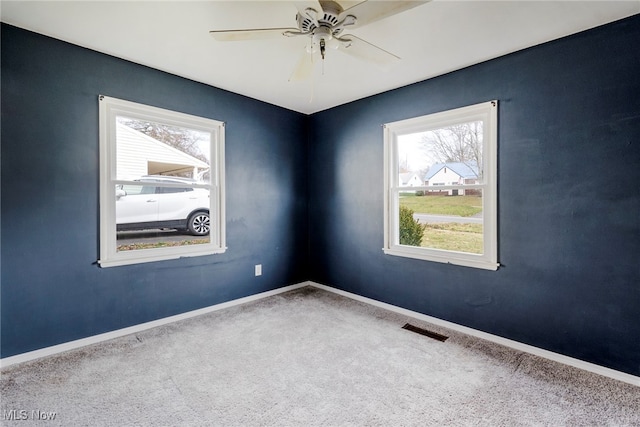 unfurnished room featuring ceiling fan and carpet floors