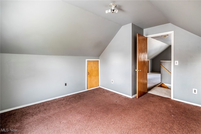 bonus room featuring light colored carpet and vaulted ceiling