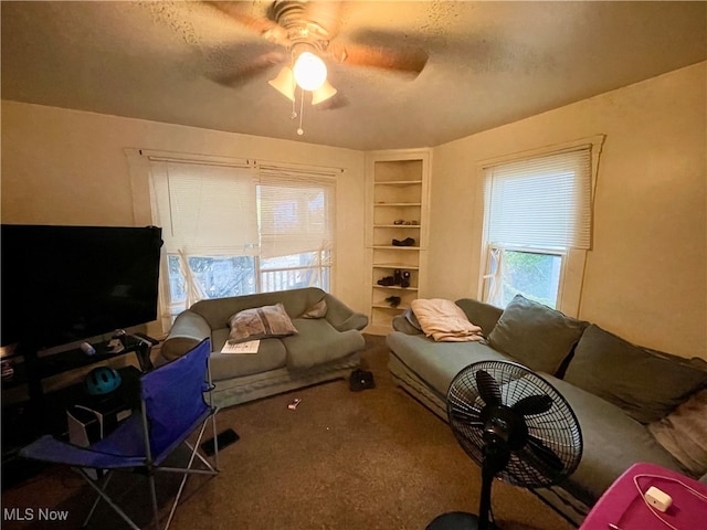 carpeted living room with a textured ceiling and ceiling fan