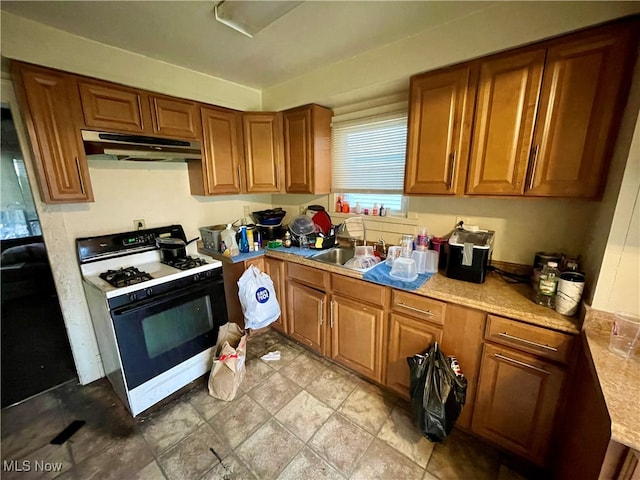 kitchen featuring gas range gas stove and sink