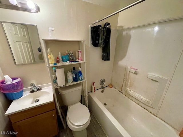 full bathroom featuring vanity, wood-type flooring, shower / bathtub combination, and toilet