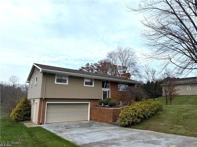 raised ranch featuring a front yard and a garage