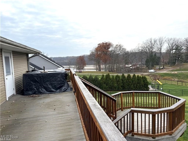 wooden terrace featuring a lawn