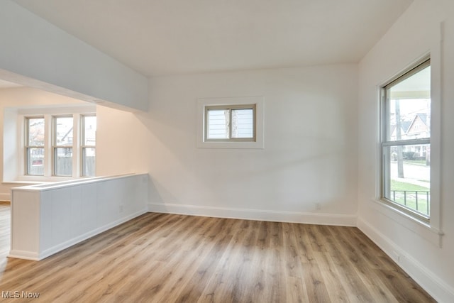 unfurnished room featuring light hardwood / wood-style floors and a wealth of natural light