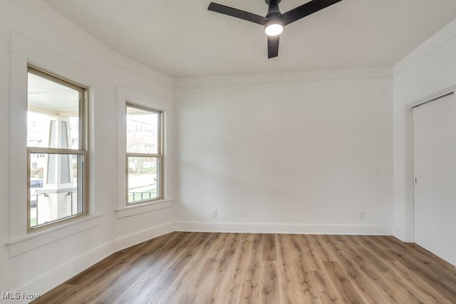 empty room with hardwood / wood-style flooring, ceiling fan, and crown molding