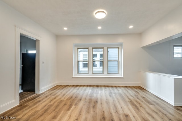 interior space with light hardwood / wood-style flooring, a healthy amount of sunlight, and a textured ceiling