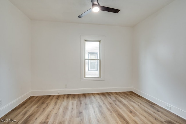 spare room with ceiling fan and light wood-type flooring