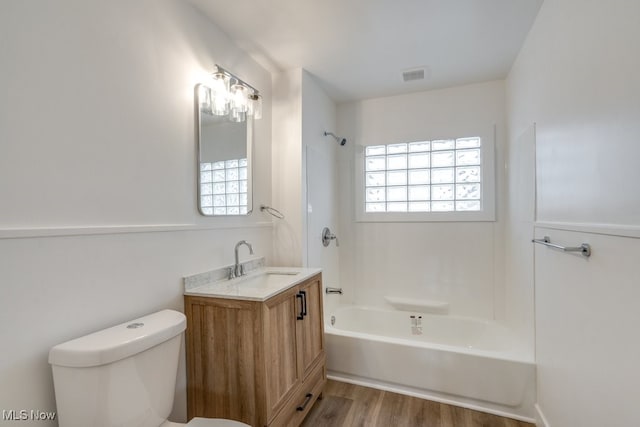 full bathroom featuring hardwood / wood-style floors, vanity, toilet, and a wealth of natural light