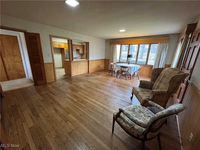 living area featuring wood walls and hardwood / wood-style flooring