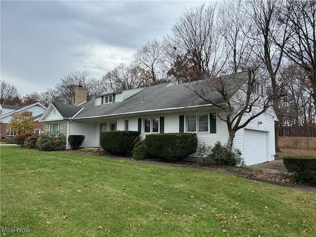 view of front of home with a garage and a front lawn