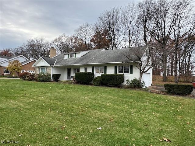 view of front of property featuring a garage and a front lawn