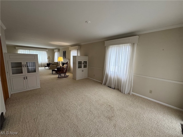 carpeted empty room featuring crown molding and a wall unit AC