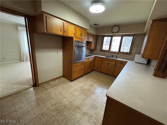 kitchen featuring black oven, sink, and light carpet