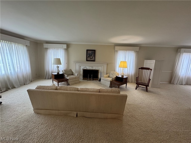 living room featuring a wall mounted air conditioner, light colored carpet, and a healthy amount of sunlight