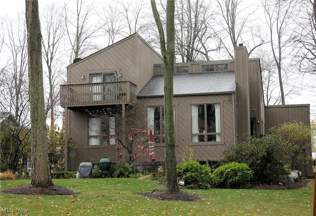 exterior space featuring a front yard and a balcony