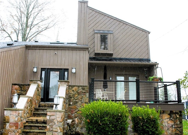 rear view of property with a balcony