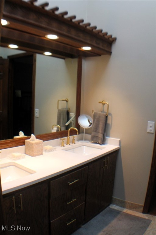 bathroom with tile patterned floors and vanity