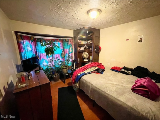 bedroom featuring carpet flooring and a textured ceiling