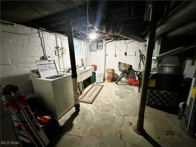 basement with electric panel and washer and dryer