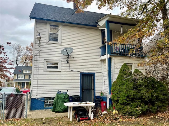 back of house with a balcony