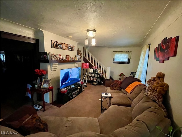 living room featuring carpet floors and a textured ceiling