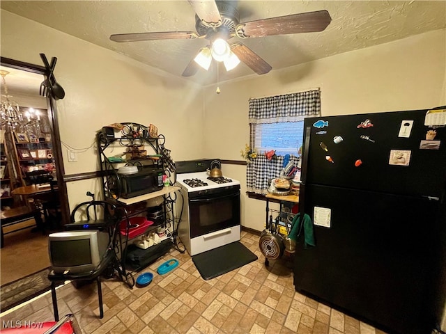 kitchen featuring black refrigerator, white range with gas cooktop, and ceiling fan