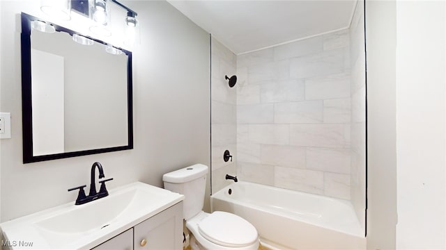 full bathroom featuring vanity, toilet, and tiled shower / bath