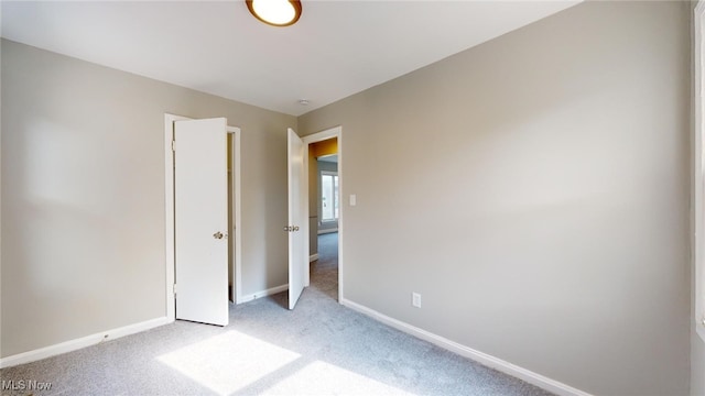 unfurnished bedroom featuring light colored carpet