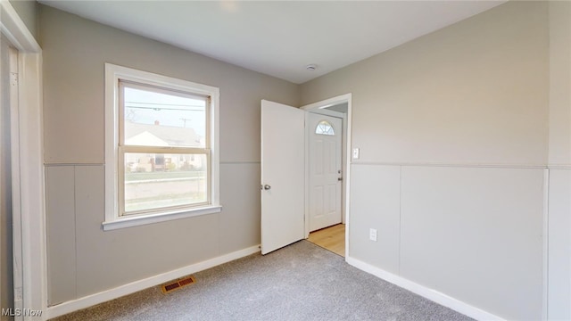 empty room featuring light carpet