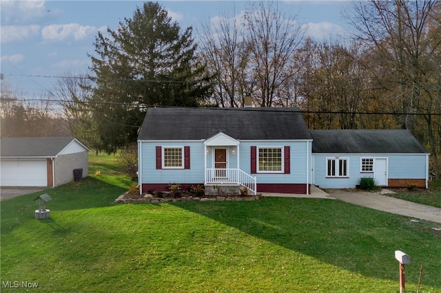 view of front of property with a garage, an outbuilding, and a front yard