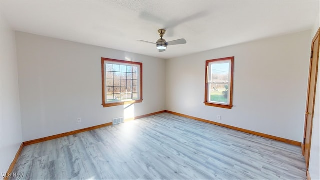 spare room featuring light hardwood / wood-style flooring and ceiling fan