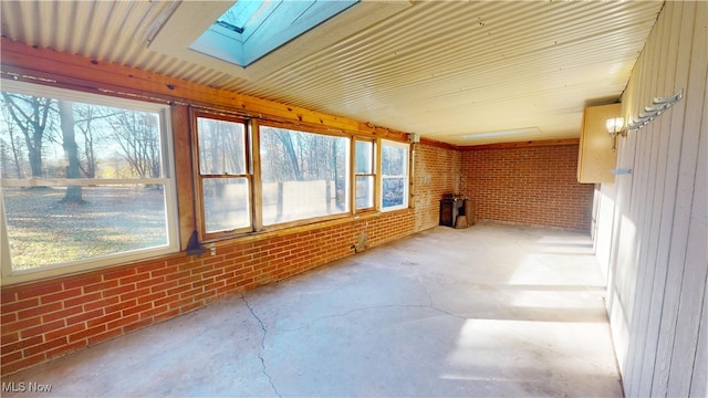 unfurnished sunroom featuring a skylight and a healthy amount of sunlight