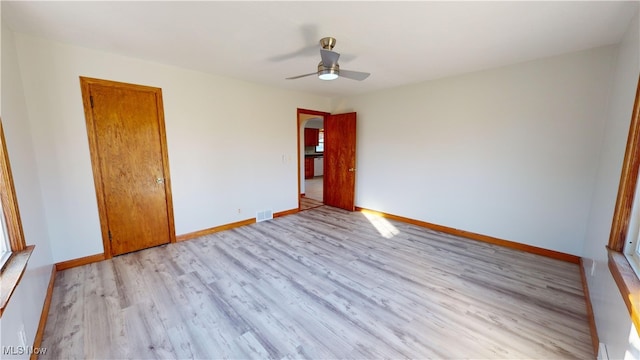 spare room with light hardwood / wood-style floors and ceiling fan