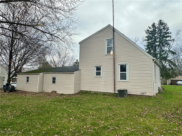 view of side of home with a lawn