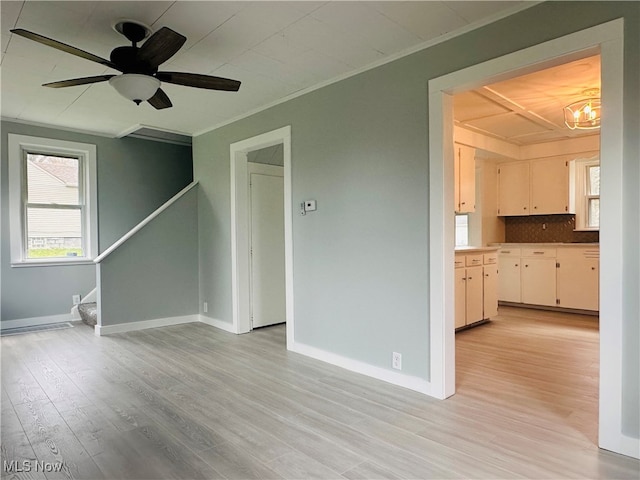 unfurnished living room with ceiling fan, crown molding, and light hardwood / wood-style flooring