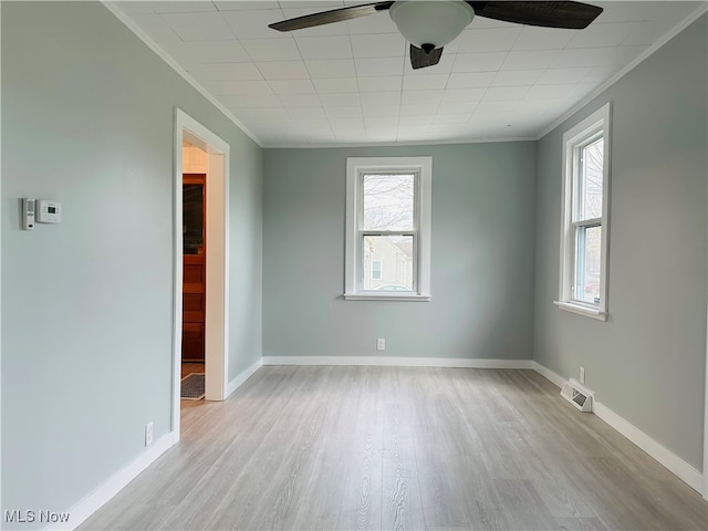 unfurnished room featuring ceiling fan, ornamental molding, and light wood-type flooring