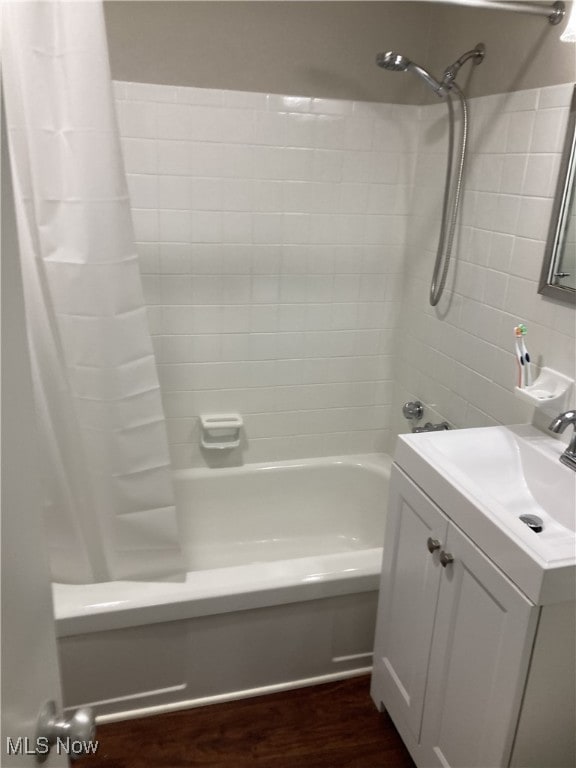 bathroom with hardwood / wood-style floors, vanity, and shower / bath combination with curtain