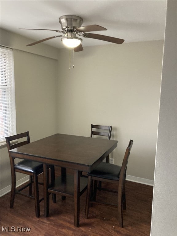 dining room with dark hardwood / wood-style flooring and ceiling fan