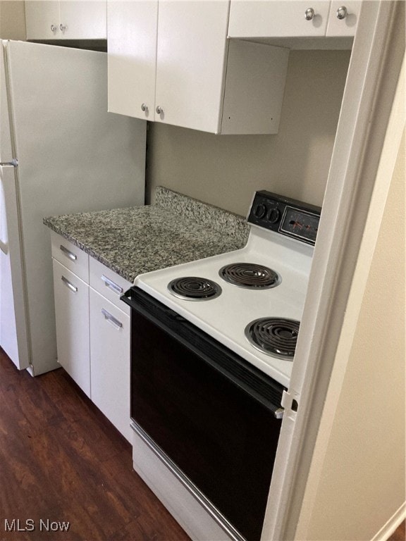 kitchen with white cabinets, dark hardwood / wood-style flooring, white appliances, and light stone counters