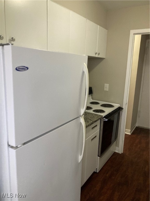 kitchen with white cabinets, white appliances, and dark stone counters