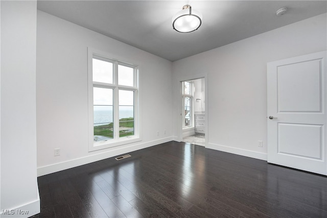 empty room with dark hardwood / wood-style floors