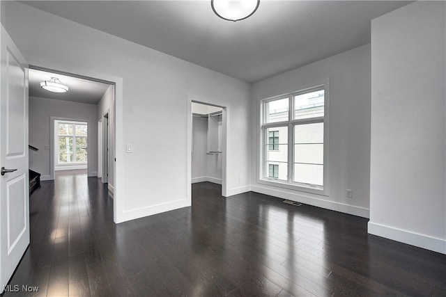 empty room featuring dark hardwood / wood-style flooring