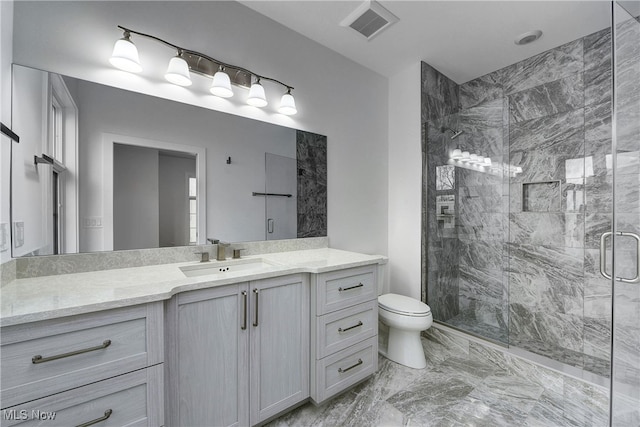 bathroom featuring vanity, toilet, and an enclosed shower