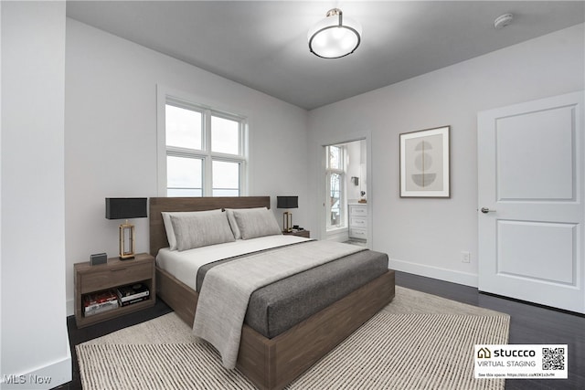 bedroom featuring dark wood-style flooring and baseboards