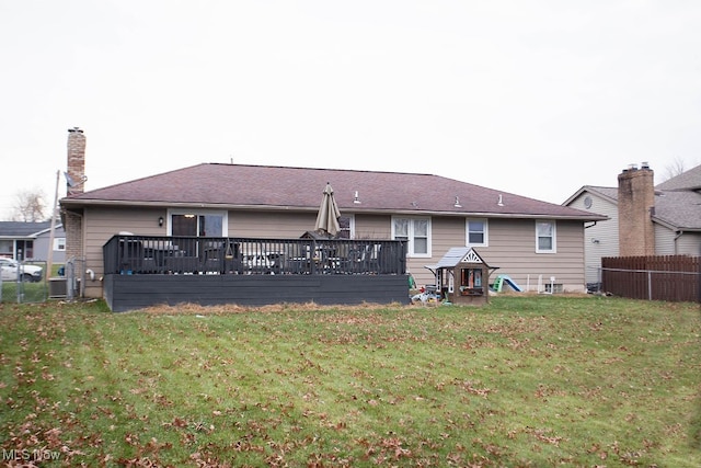 back of house featuring a yard and a deck